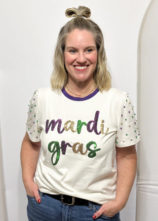 Short sleeve top with pearl accents with sequin "Mardi Gras" wording.