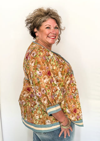 Fall floral Babydoll top with 3/4 puff sleeve, cream and blue strip detail on banding of hem and sleeve. blue ribbon detail on the front and tie at the collar. 