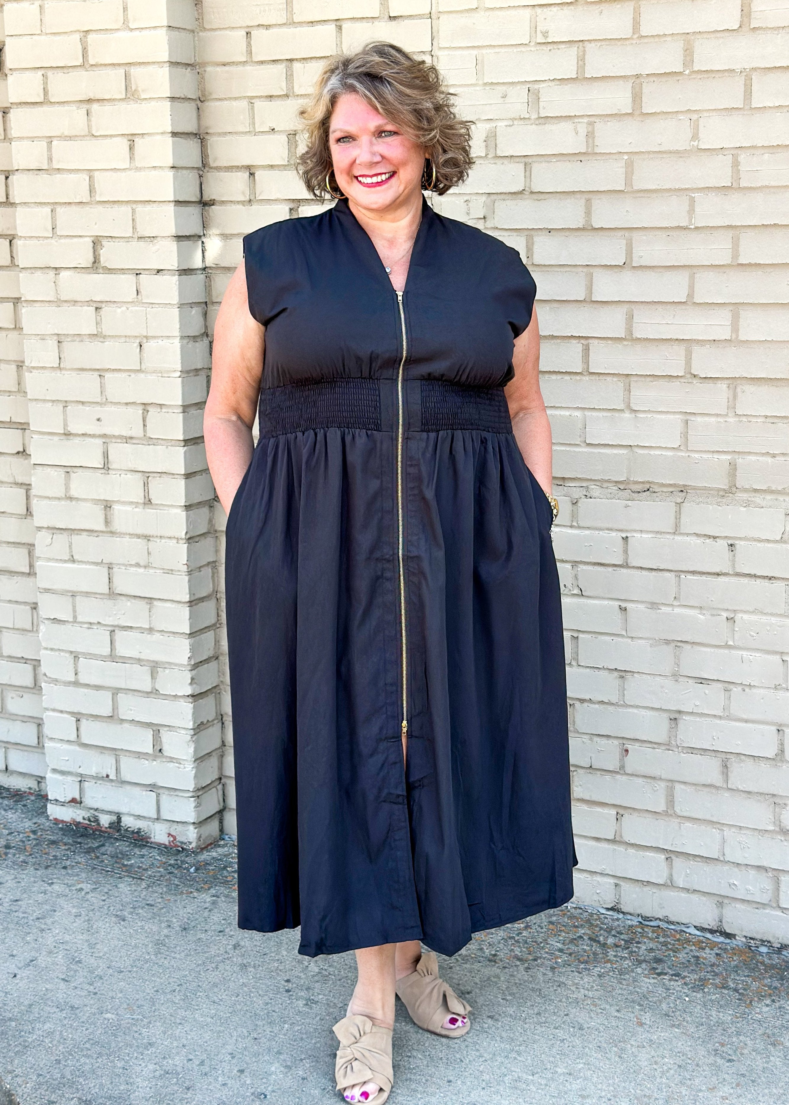 entro brand black midi dress with gold zipper down the front, smocked waistband, lined and pockets