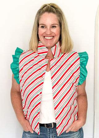 Holiday puffer vest with diagonal red, green, pink and white stripes. Snap closures, ruffle sleeves and front pockets.