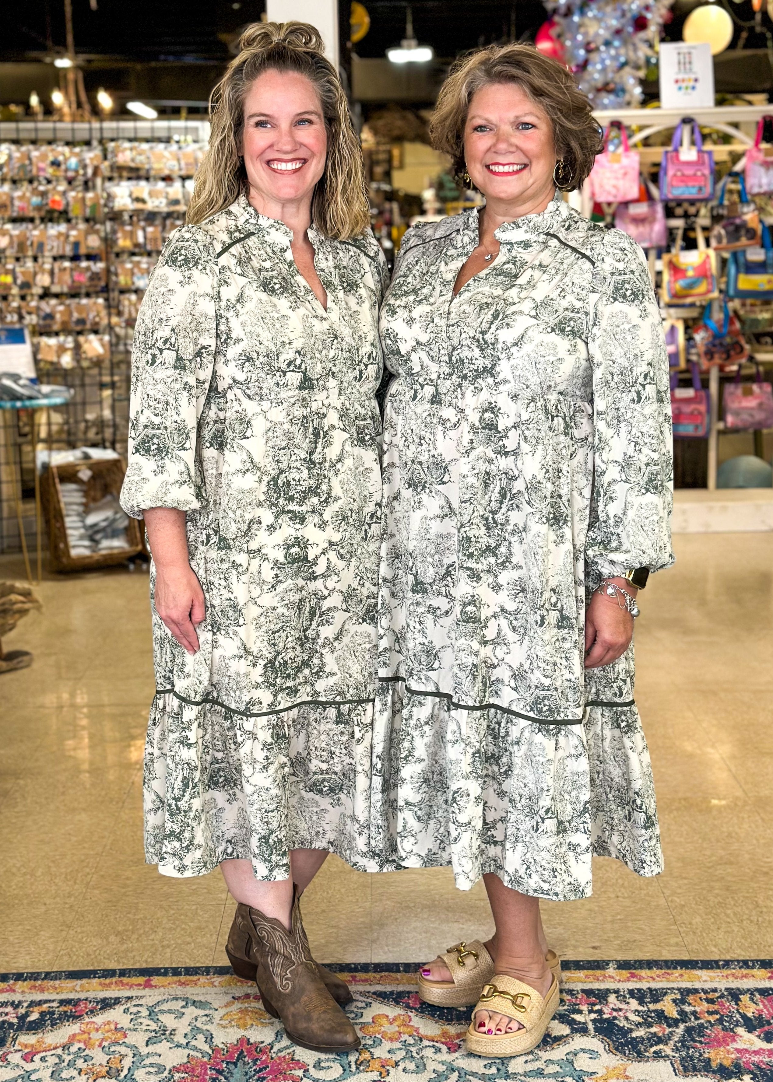 toile midi dress with forest green design – tiered – piping detail on bottom tier and around shoulder area – v-neck with ruffle – elastic ¾ sleeve