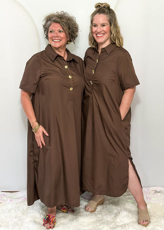 Models wearing short sleeve, collared, Brown midi dress with decorative gold snaps.