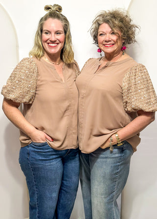 Rose-colored top featuring sparkly sequin puff sleeves and a relaxed, flowy body.