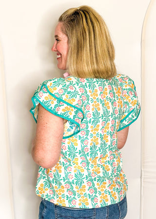 Floral print top with decorative neckline and short ruffle sleeves