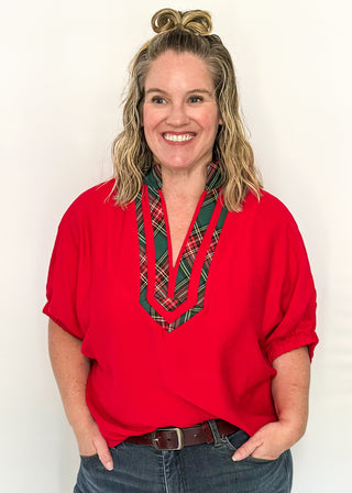 Red dolman sleeve top with plaid contrast neckline and trim detail
