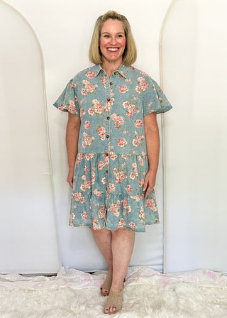 woman wearing button front denim dresses with pink floral design.  