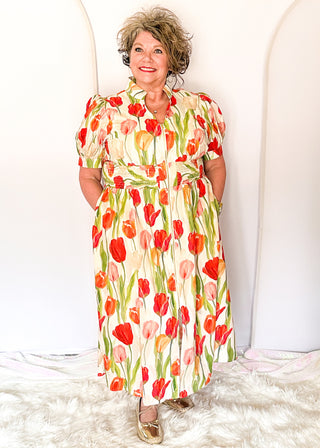 Tulip print midi dress with short sleeves, smocked waist, pockets, and lined fabric