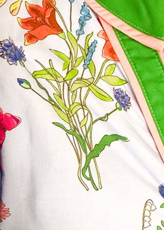 Close up of button up floral dress with contrast trim and belt, short sleeves