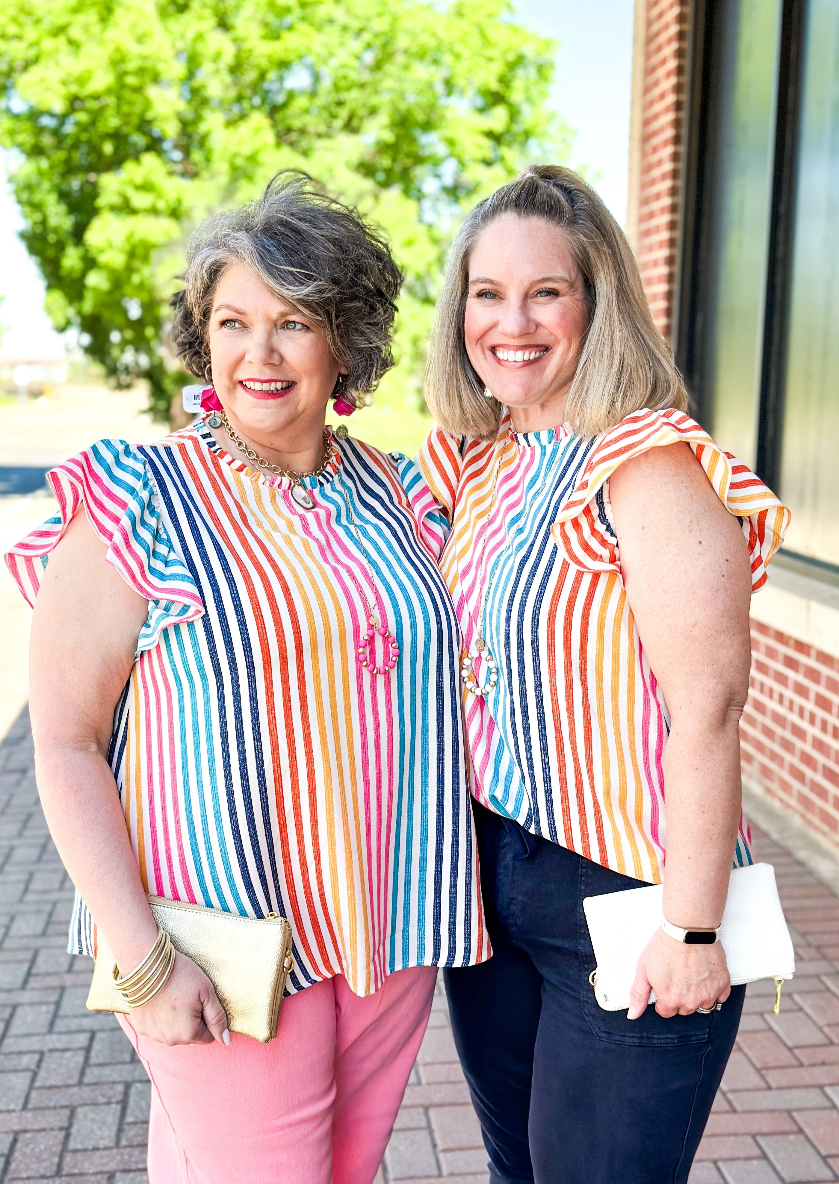 vertical striped top with ruffle sleeve and neck - keyhole back with button closure - ruffle sleeve - stripes pink, navy, light blue, yellow