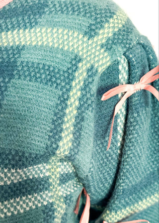 Turquoise plaid short sleeve sweater with pink trim and bow accents on the sleeves