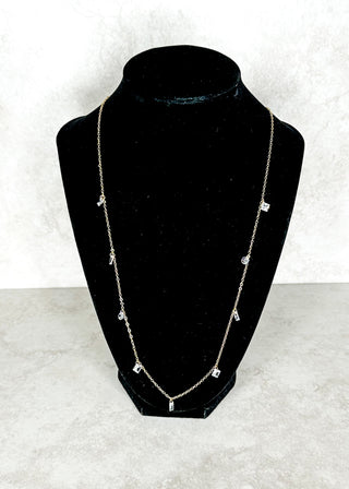Necklace on a black bust against a white background