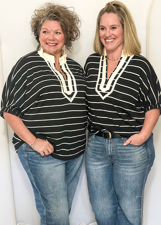Black and cream striped dolman top with cream trim and flowy short sleeves.