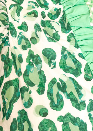 Close up of green animal print blouse with contrast trim, button front, and ruffle sleeves