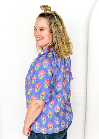 periwinkle floral top with puff short sleeves and v-neck