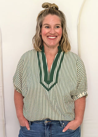 Model wearing a Hunter Green-colored Entro dolman striped top with contrast trim, styled in a relaxed, casual fit.