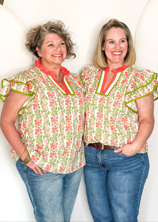 Floral print top with decorative neckline and short ruffle sleeves