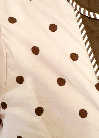 close up of Ecru button up top with brown polka dots. 