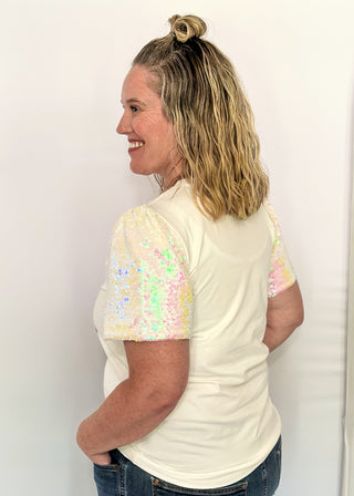 Short sleeve top with iridescent sequin sleeves and pastel sequin Christmas tree appliqués on the front.
