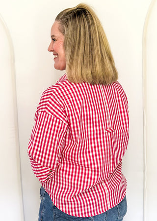 Gingham blouse with split neckline, collar, and 3/4 sleeves.