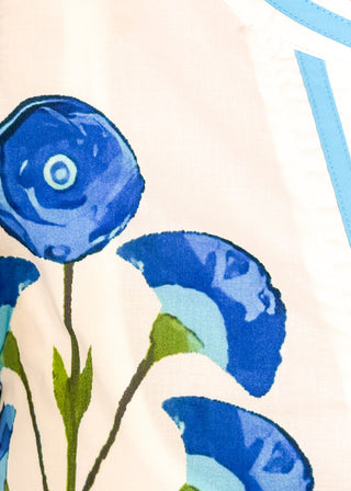 close up of white top with oversized blue flower pattern and short sleeves