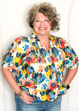 Multicolor floral blouse with smocked detail and short sleeves