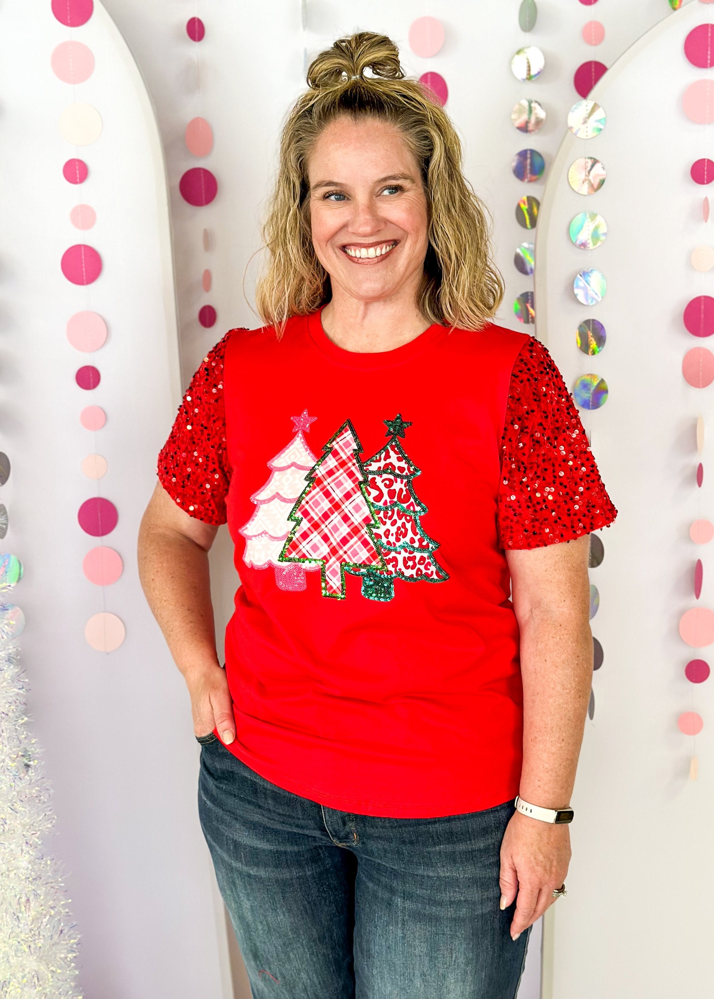 white short sleeve top with iridescent sequin sleeves, round neck, sparkly trio of trees patch on the front