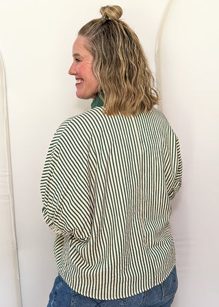 Model wearing a Hunter Green-colored Entro dolman striped top with contrast trim, styled in a relaxed, casual fit.