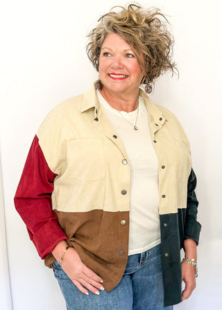 Colorblock corduroy shacket with front and side pockets. featuring cream, camel, forest green, and dark red panels, long sleeves, and snap-front closure