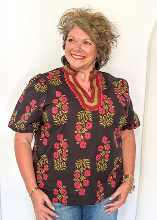 floral black -neck with ribbons of green and wine around v-neck and same colored floral pattern on  top - short sleeve