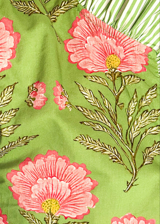 close up of matcha green floral puff sleeve blouse with pink oversized floral print and striped contrast trim along the neckline and front placket.