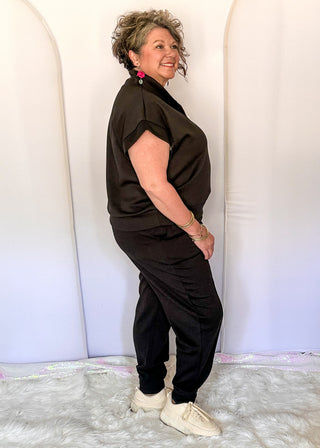 Black elastic waist jogger pants with cuffed ankles