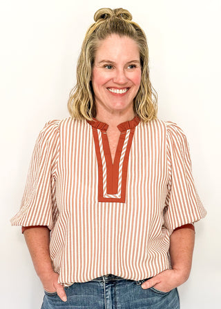 Cinnamon-brown striped blouse with a split neckline, contrast trim, and 3/4 sleeves.