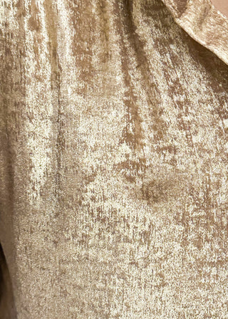 Close up of shimmer gold lightweight button up blouse with collared neckline and ruched sleeves.
