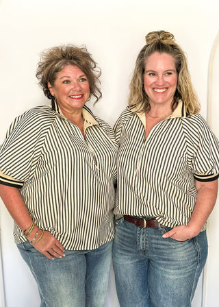 Short sleeve black and off white vertical stripes, zip front collar.  Collar and sleeve has contrast trim with bold stripe