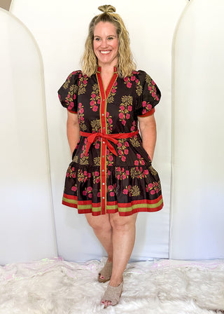 Short sleeve belted dress in black with berry florals and contrast piping.  Button up. 