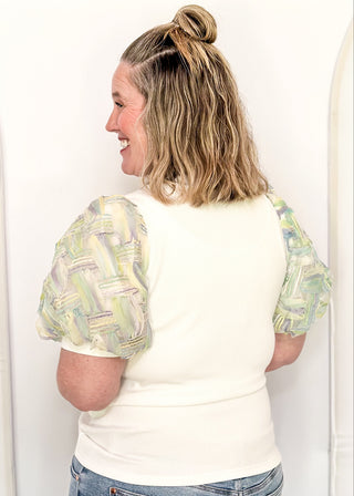 White ribbed knit top with pastel watercolor puff short sleeves. 