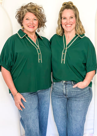 Emerald green short-sleeve blouse with contrast stitched collar and neckline, ruched sleeves, and a loose, relaxed fit