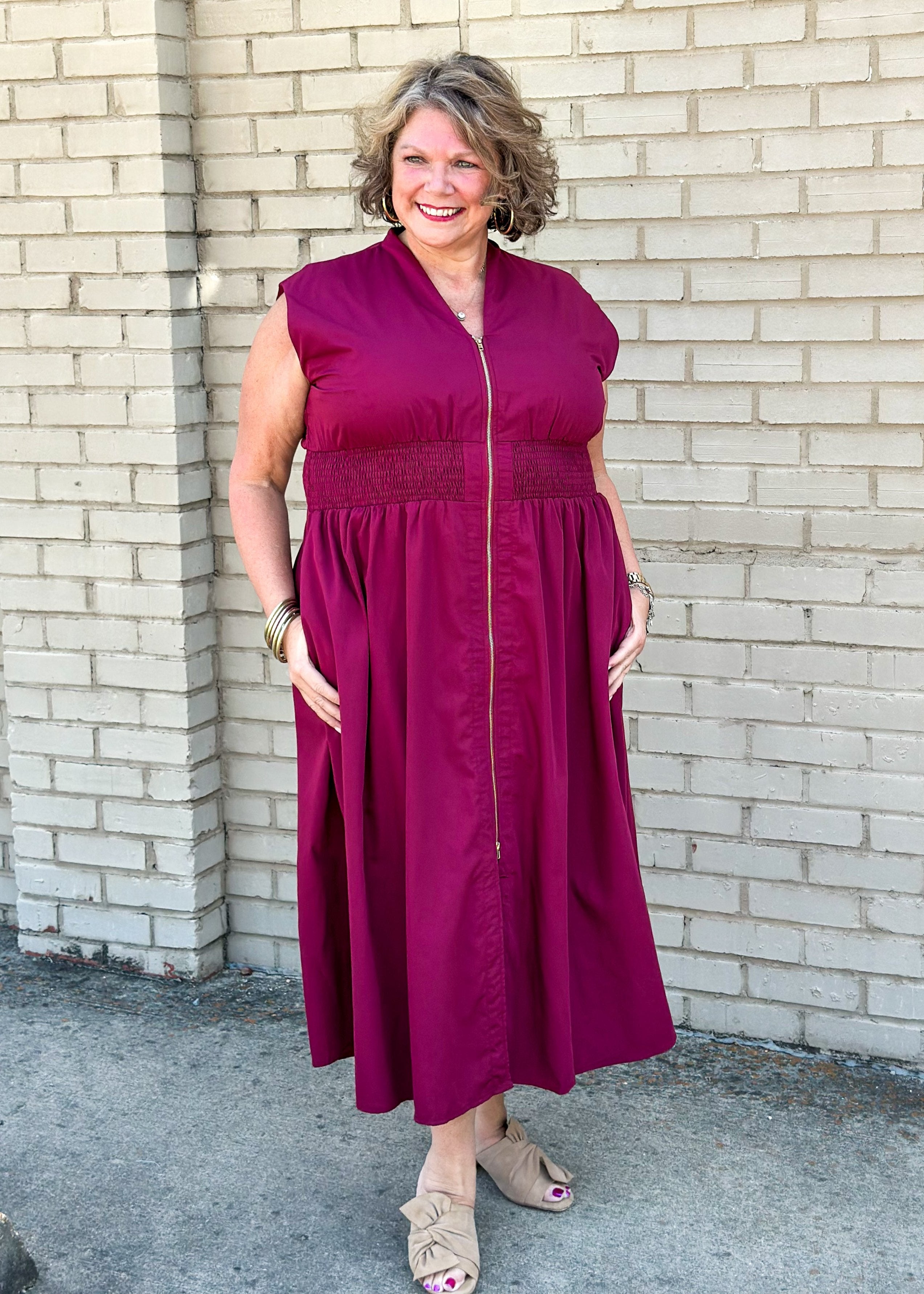 entro brand merlot colored midi dress with gold zipper down the front, smocked waistband, lined and pockets