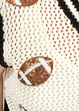 Cream open weave sleeveless sweater - need to wear something underneath - football sequin patches and black and cream varsity style trim around v-neck and bottom banding.