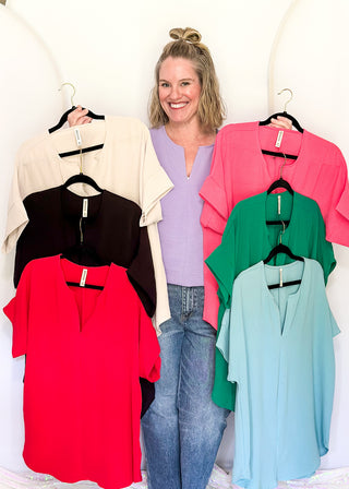Solid textured blouse with a V-notch neckline, short sleeves in all colorways