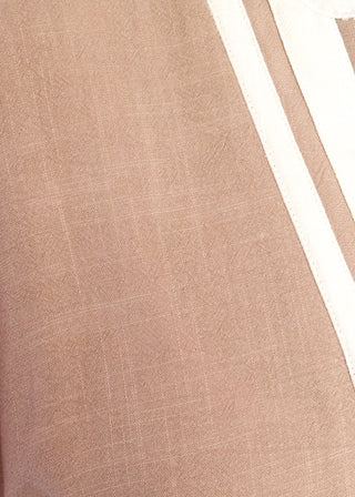 close up of light brown short sleeve maxi dress with white contrast collar and detail with pockets. 