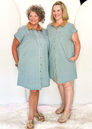 Two women modeling a denim button up dress with camel corduroy collar and pockets.