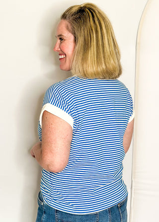 Blue and white striped short sleeve top with white banding on sleeve and collar. 