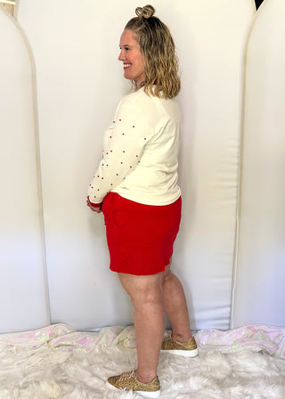 Bright red ribbed skort with drawstring waist and side pockets.