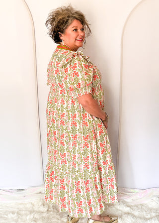 Floral midi dress with contrast neckline, short puff sleeves, and tiered skirt