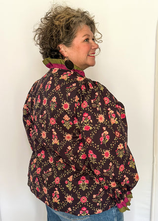 Deep navy floral ruffle trim long sleeve top with rich pink and olive accents.