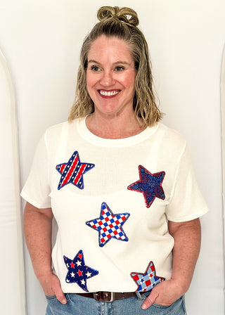 White Ribbed short sleeve top with patriotic star patches, sequin detail.