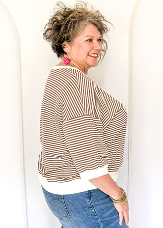 Striped knit dolman top with crew neckline and ribbed trim in brown.