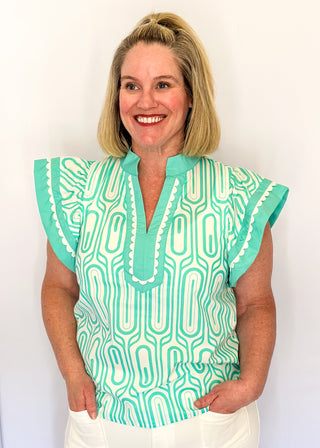 Patterned short-sleeve top in mint with contrast trim with scallops, v-neckline.
