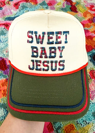 Snapback hat with 'Sweet Baby Jesus' plaid lettering and embroidered detail on bill.